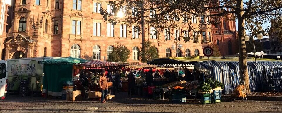 A market in front of a large building in Wiesbaden, Germany