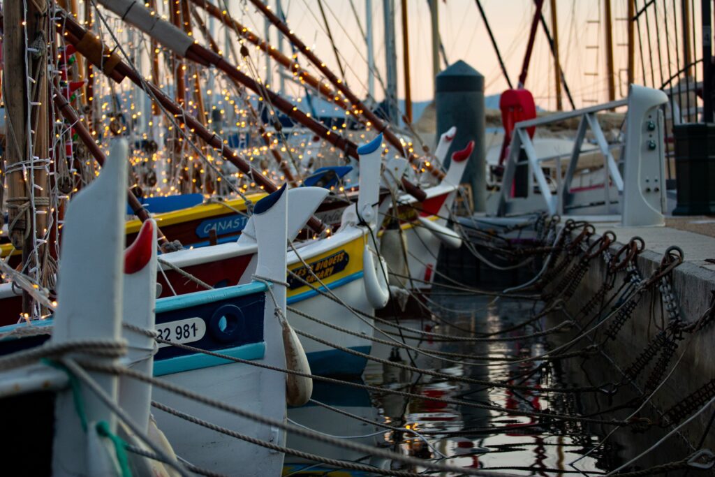 Smalls boats tied to the deck at sunset