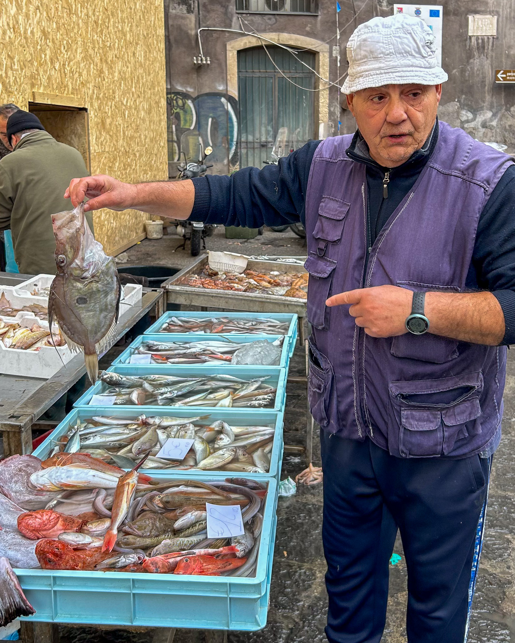 A fishmonger at La Pescheria, the fish market in Catania